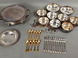 a lot of silverware and silverware on a table