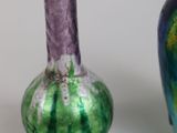 two vases sitting next to each other on a table
