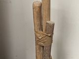 a wooden pole that is on the floor next to a chair