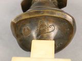 a close up of a bronze object with a cross on it