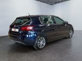 the back end of a blue car in a white room