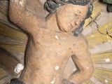 a statue of a boy holding a tree branch