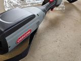 a corded blower sitting on the floor next to a pair of scissors