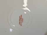 a white plate with a red and white design on it