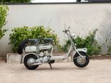 a motorcycle parked in a parking lot next to a wall