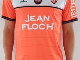 Cet homme porte un maillot de foot orange et blanc.