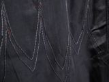 the back of a black leather jacket with stitching on it
