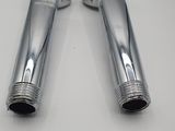 pair of chrome exhaust pipes for a car with nozzles