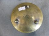 a brass clock with a sticker on it