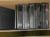 a box full of dvds on a shelf in a room