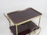 a brown and gold bar cart with a glass top