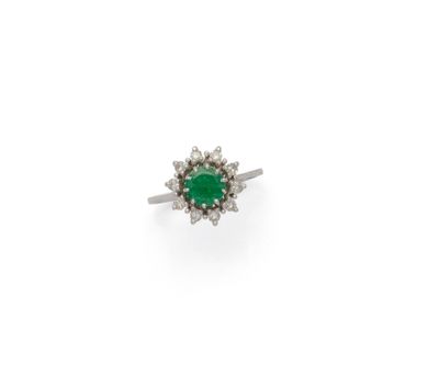 an emerald and diamond cluster ring