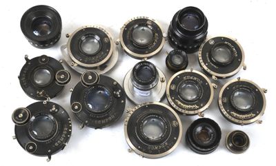 a lot of old cameras sitting on a white surface