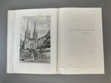 an open book with a drawing of a church in the background