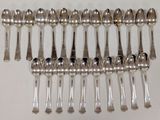 a lot of silver spoons that are on a table