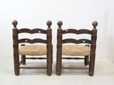 pair of antique wooden chairs with wicker seat and wooden frame