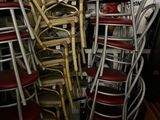 a lot of chairs and a table in a room