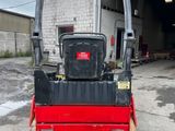 a close up of a red and black roller on a street