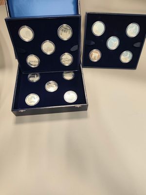 a couple of silver coins sitting in a box on top of a table
