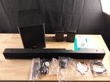 a wooden table with speakers and remotes on top of it