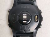 the back of a black watch with two buttons on the face