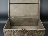 an old wooden box with carvings on the inside of it