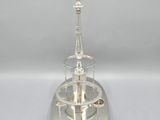 a silver plate with a tower on top of it