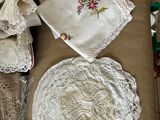 a box of doily on a table with a glass of wine and napkins