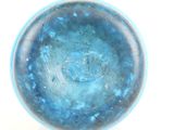 underside view of a blue glass bowl on a white surface