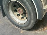 a close up of a flat tire on a truck