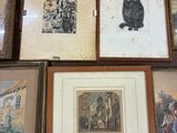 many framed pictures of cats on a table