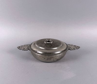 an antique silverplated casserole dish with a lid
