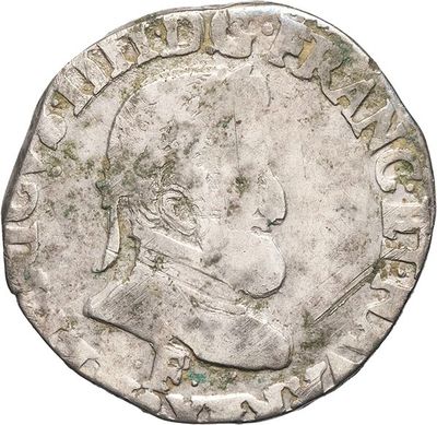 a close up of a silver coin with a man ' s face on it