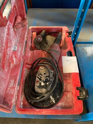a red case with a tool in it on a blue table