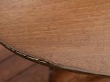 a close up of a wooden table with a clock on it