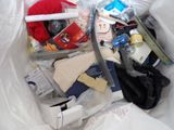 a plastic bag filled with various items on a bed