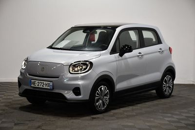 la petite voiture blanche est garée sur un sol en damier