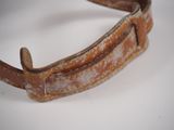 an old leather belt on a white surface with a white background
