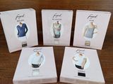 four boxes of women ' s clothing sitting on a wooden table