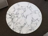 a white marble table with a laptop on it