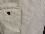 the pants are white and have a black button on the side