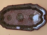 a picture of a decorative tray hanging on a wall