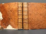 two old books that are sitting on a table