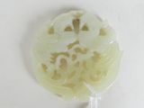 a picture of a white jade pendant with a flower design on it