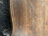 a wooden chair that has a design on it