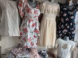 a lot of dresses on display on a table