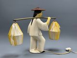a figurine of a man holding a bunch of papers