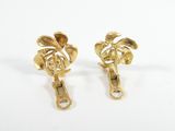 pair of gold tone earrings with leaves on them