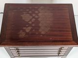 a small wooden table with a drawer on top of it