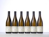six bottles of wine lined up on a table